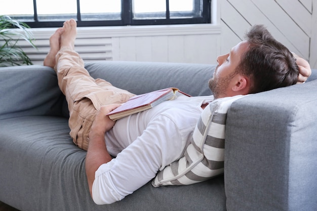 handsome-man-sleeping-couch-with-book_144627-19260.jpg